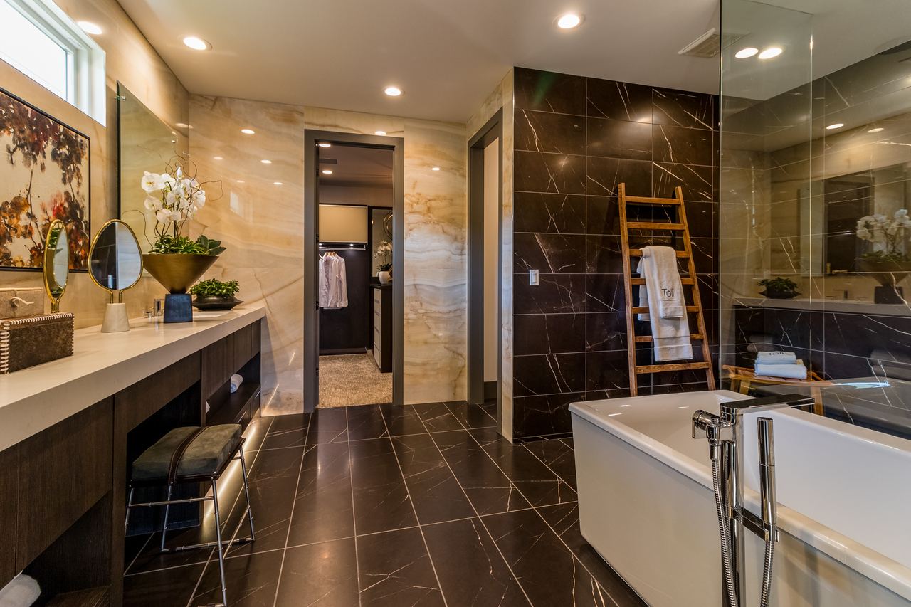 Modern bathroom with a freestanding tub and dark tile