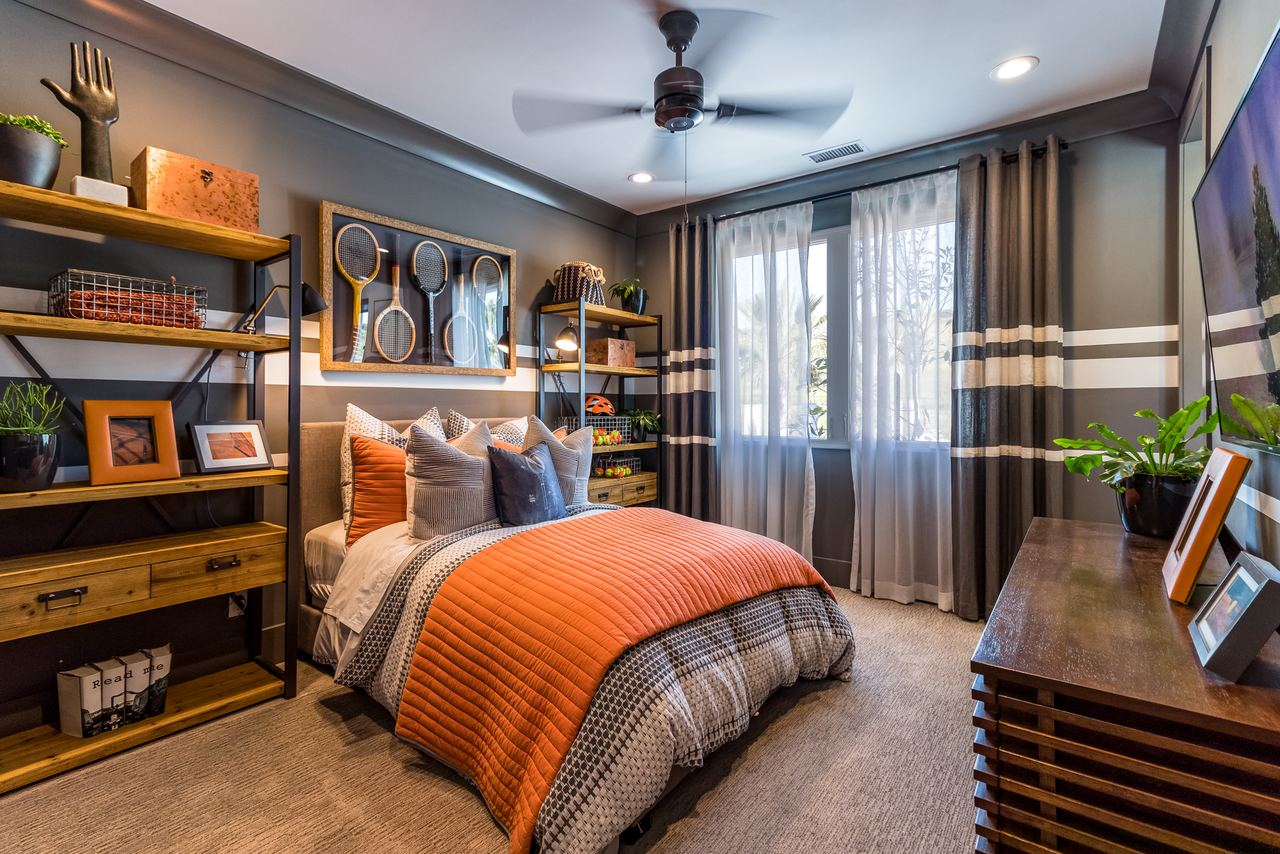 Modern bedroom with an orange throw and built-in shelving