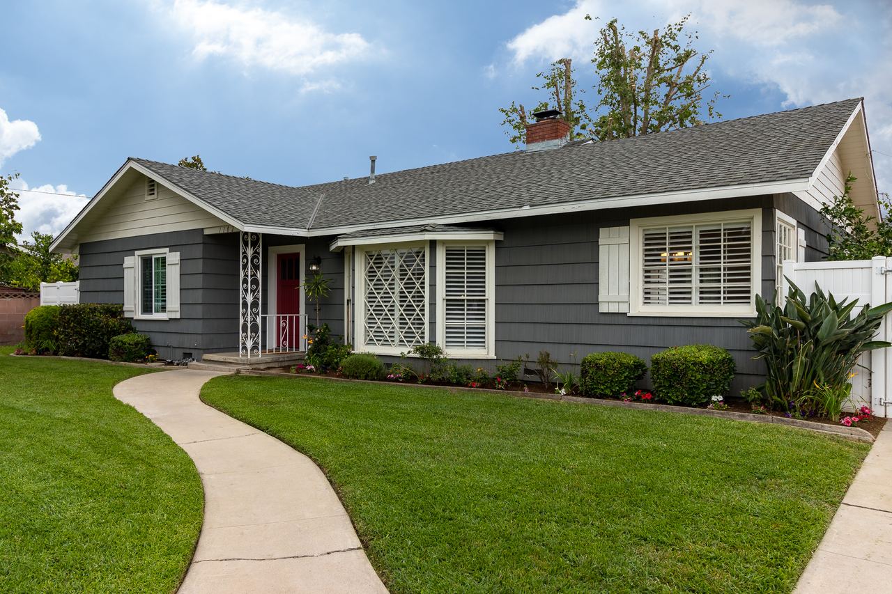 Single-story home with a curved walkway and green lawn