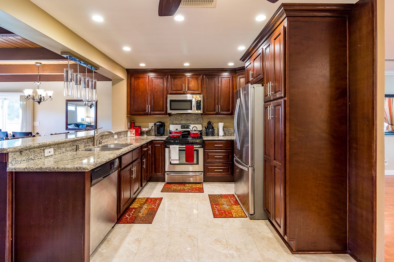 Kitchen with cherry cabinets, granite counters and stainless appliances