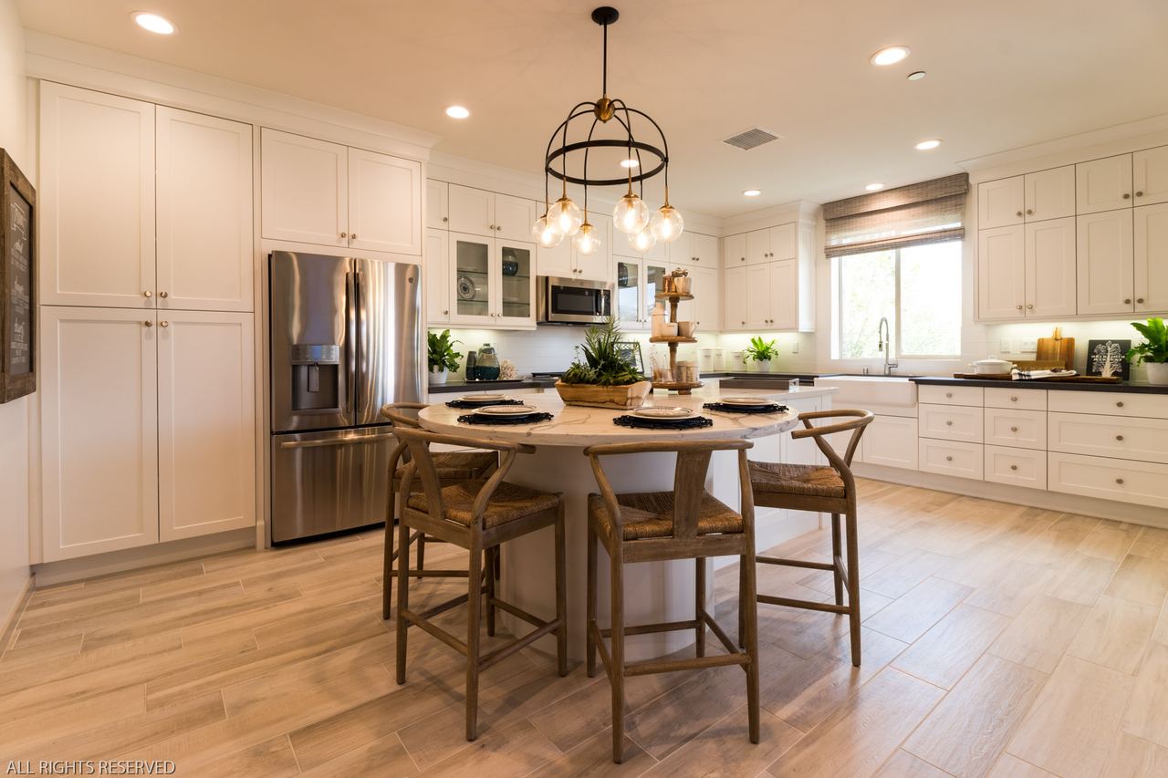 Kitchen with a wood-topped island, bar stools and stainless appliances