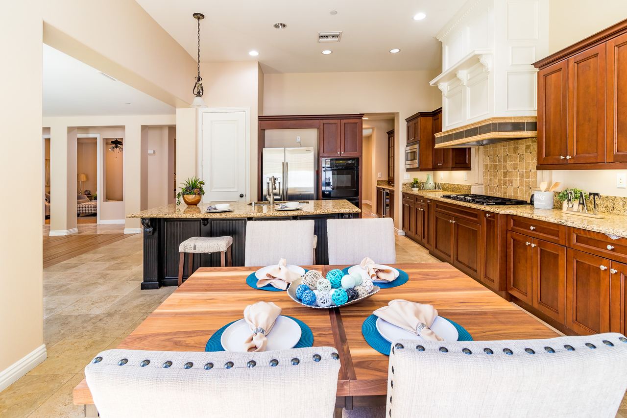Kitchen island set for brunch beneath wood cabinetry