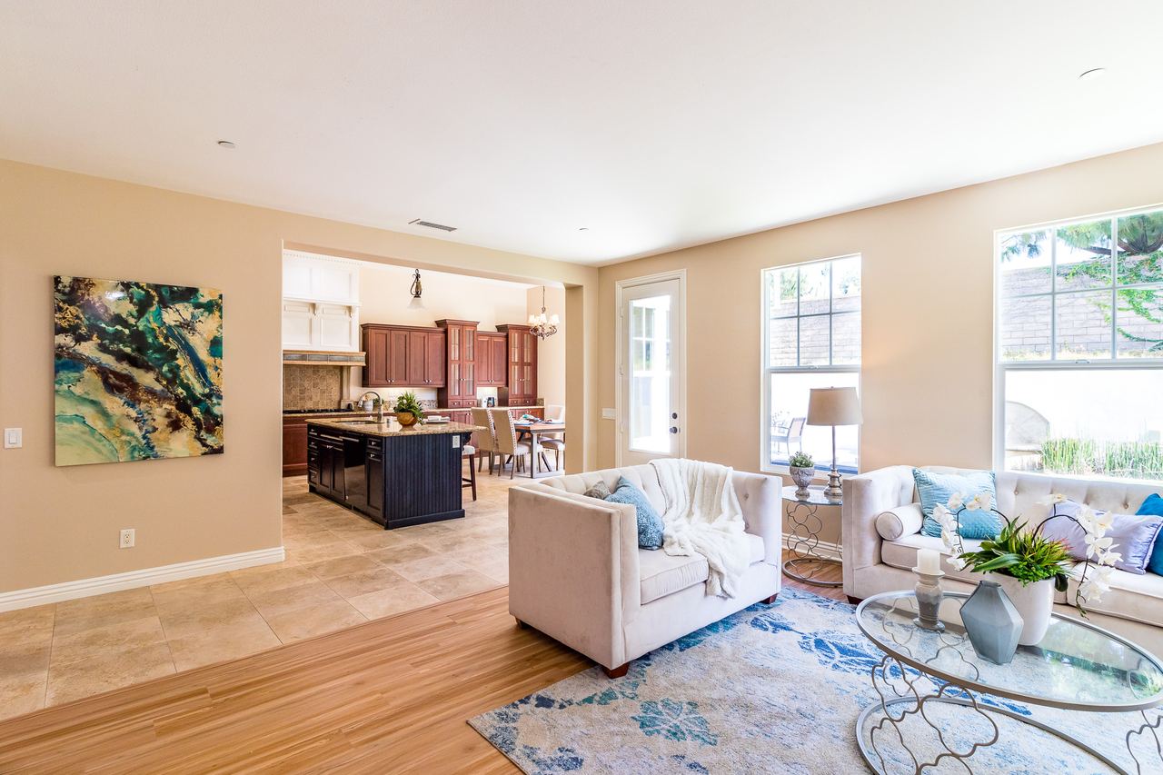 Bright living room with a stone fireplace and soft blue accents